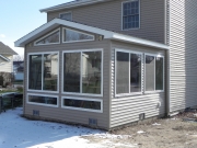 enclosed sunroom with glass around room